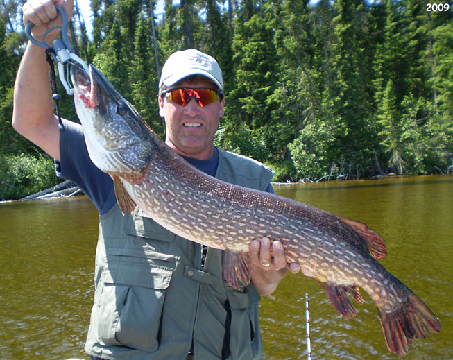 This is a photo of a man holding up a 15 pound Pike
